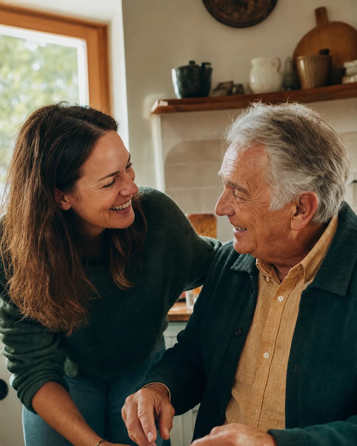 An adult daughter sharing a warm moment with her older father at home